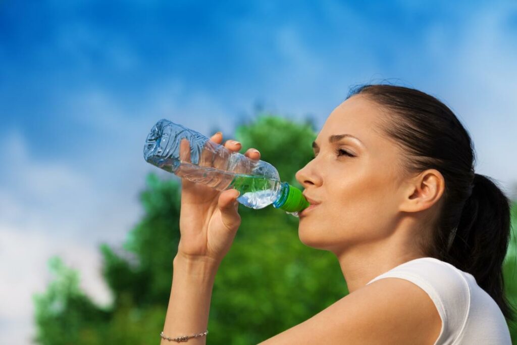 woman drinking a bottle of water